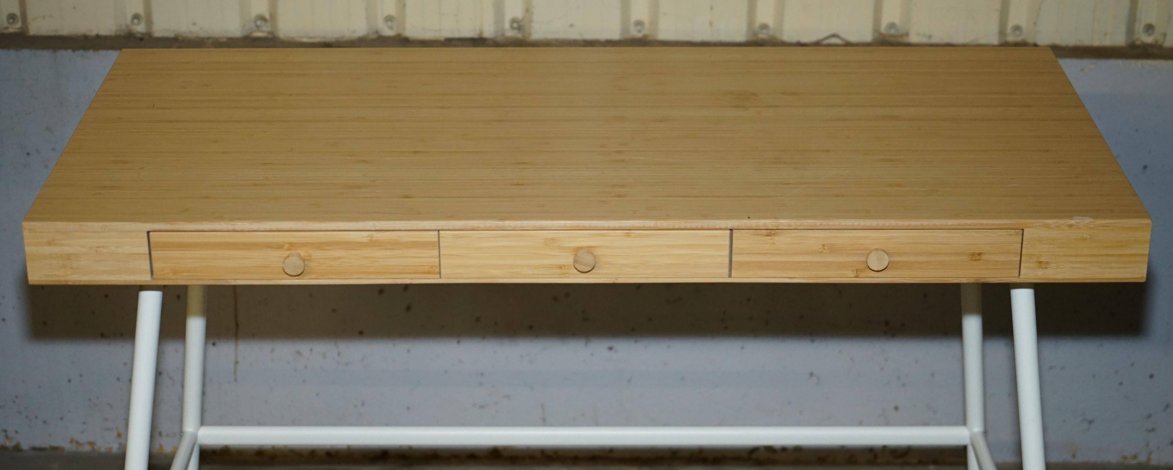 Small bamboo desk with three drawers.