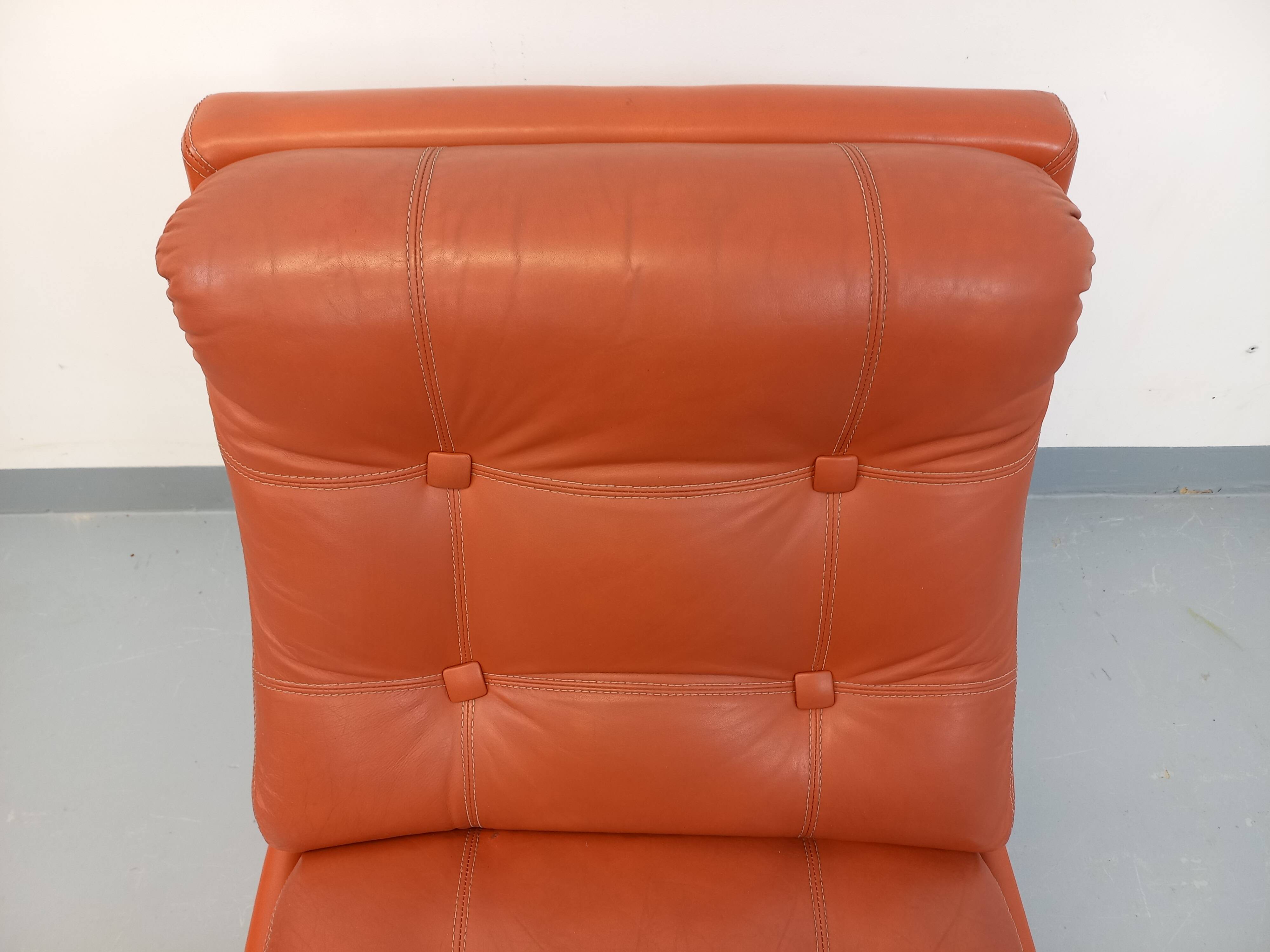 Vintage Roche Bobois armchair in chrome and terracotta leather.