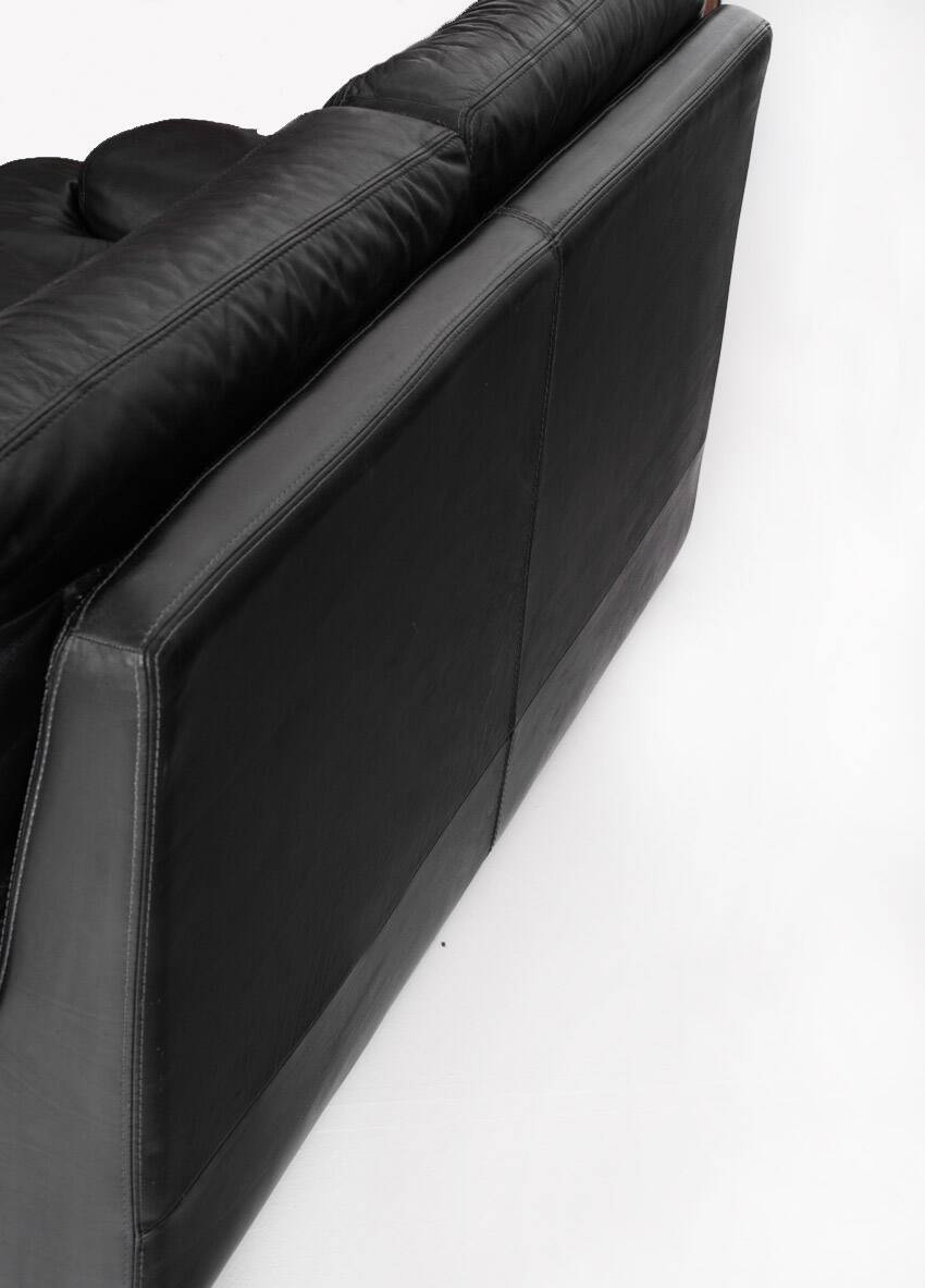 Black leather two-seater sofa. Roche Bobois edition. France, 1980s.