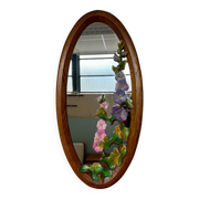 Carved wooden mirror with flower decorations.