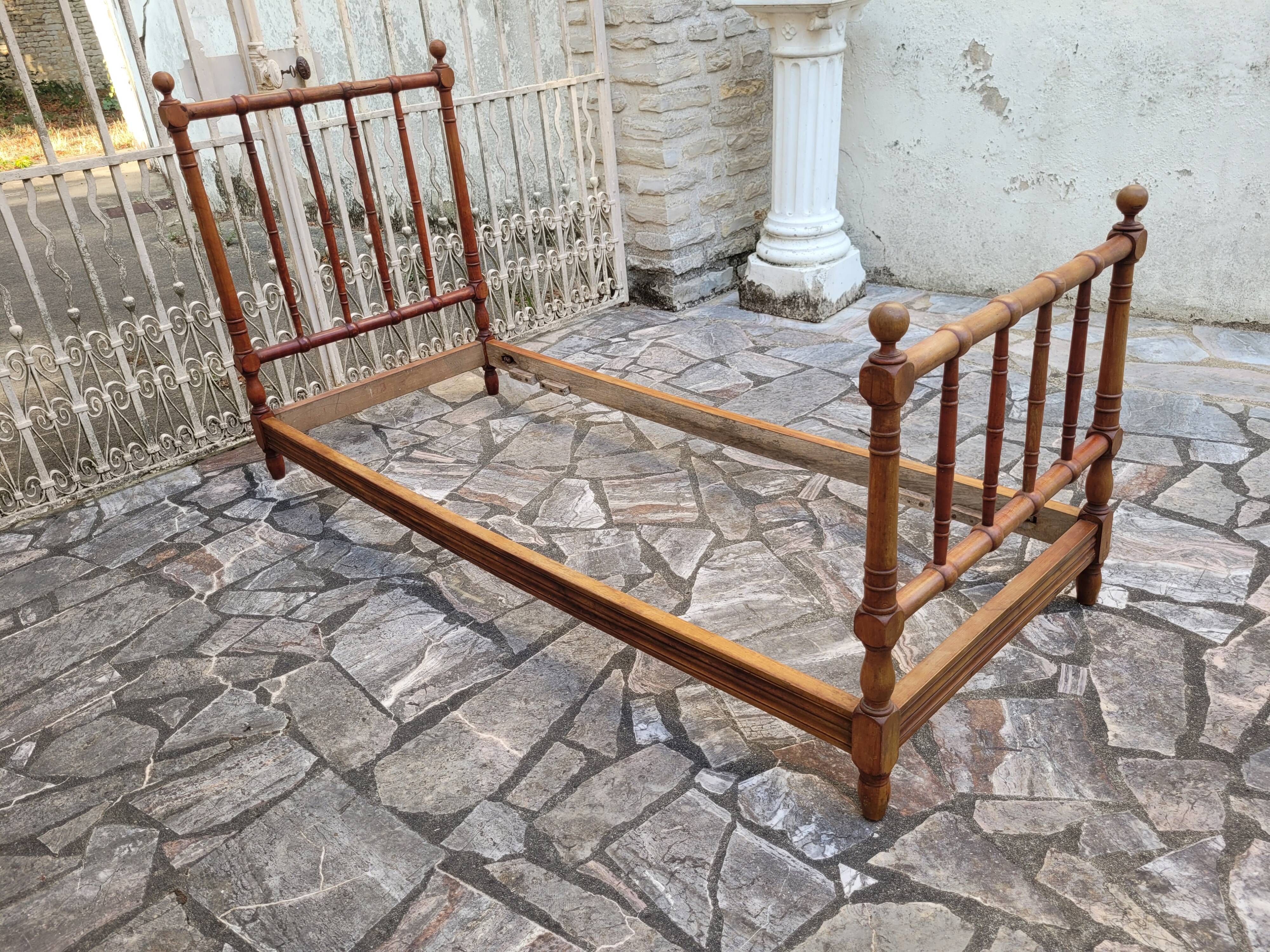 Child's bed or vintage rest bed made of solid cherry wood in a bamboo style.