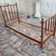 Child's bed or vintage rest bed made of solid cherry wood in a bamboo style.
