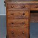 Antique Victorian oak kneehole desk with 18 double-sided drawers.