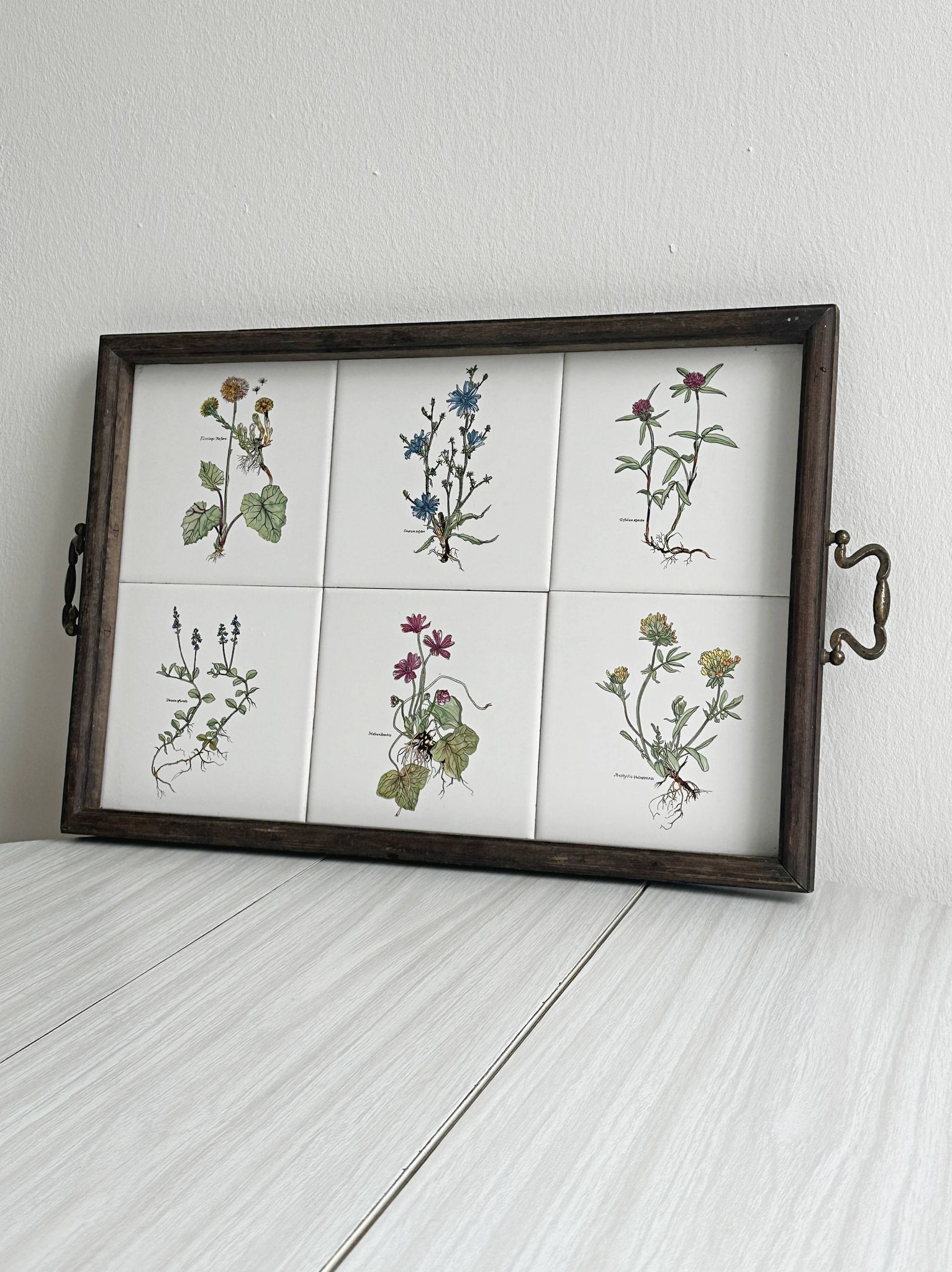 Old wooden plateau with floral tiles