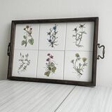 Old wooden plateau with floral tiles