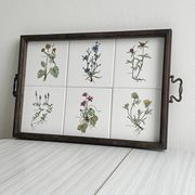 Old wooden plateau with floral tiles