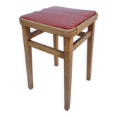 Vintage wooden stool and red skai seat
