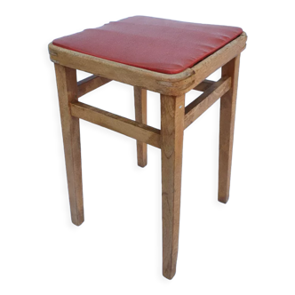 Vintage wooden stool and red skai seat