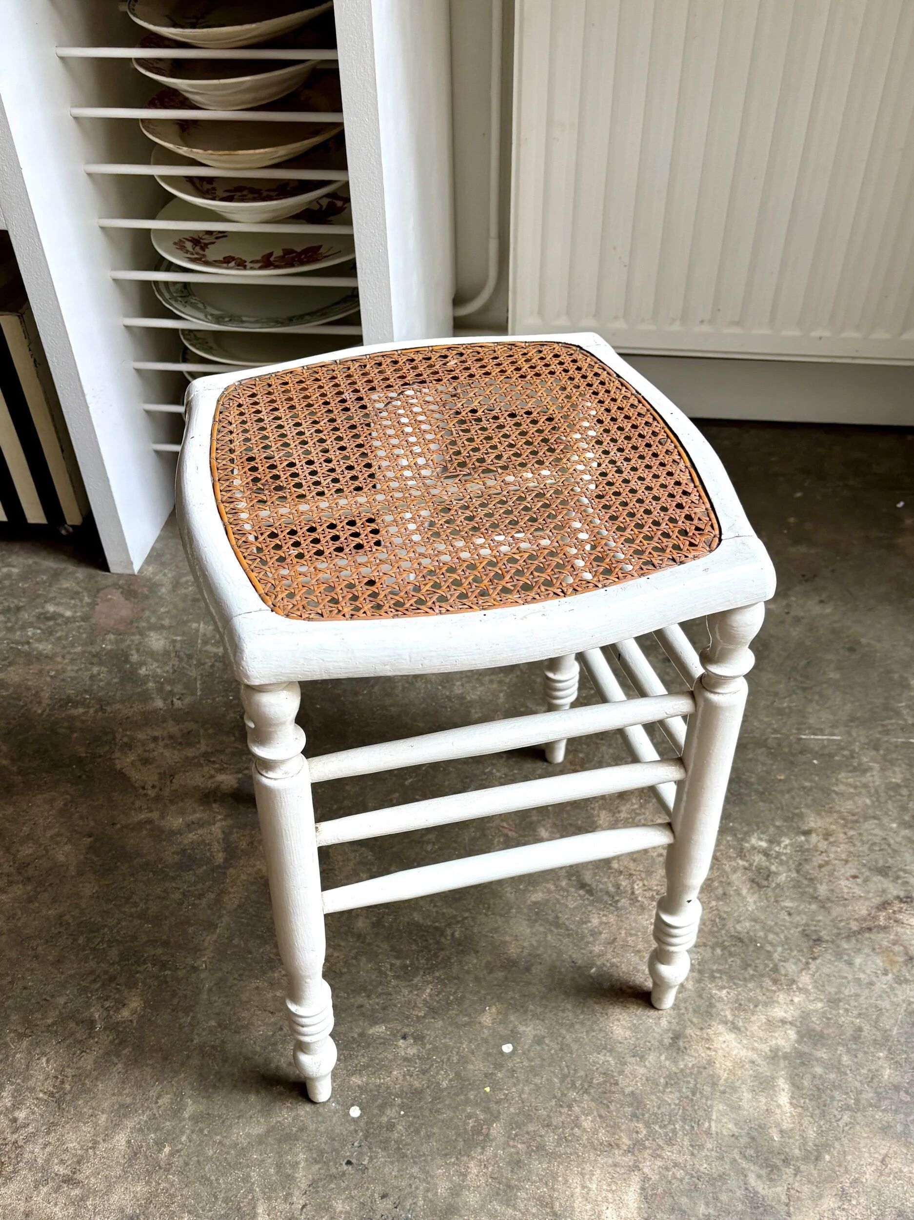 White wooden stool with caning