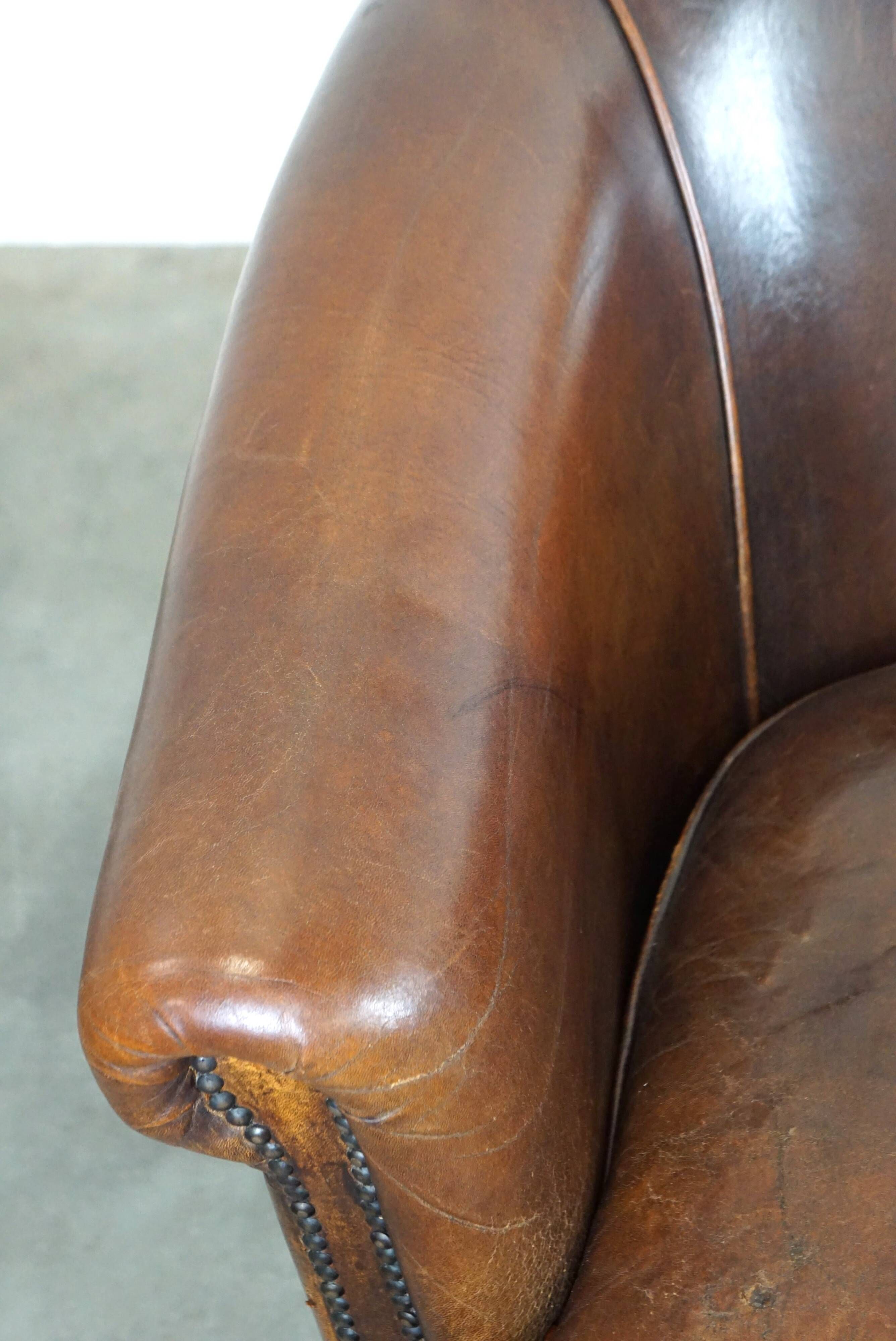 Set of two rugged sheep let of two rugged sheep leather club armchairs with a nice distressed look