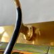 Vintage wall-mounted coat rack in golden aluminum - triple coat hook
