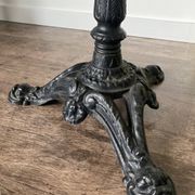 Bistro table with a central cast iron base in industrial style.