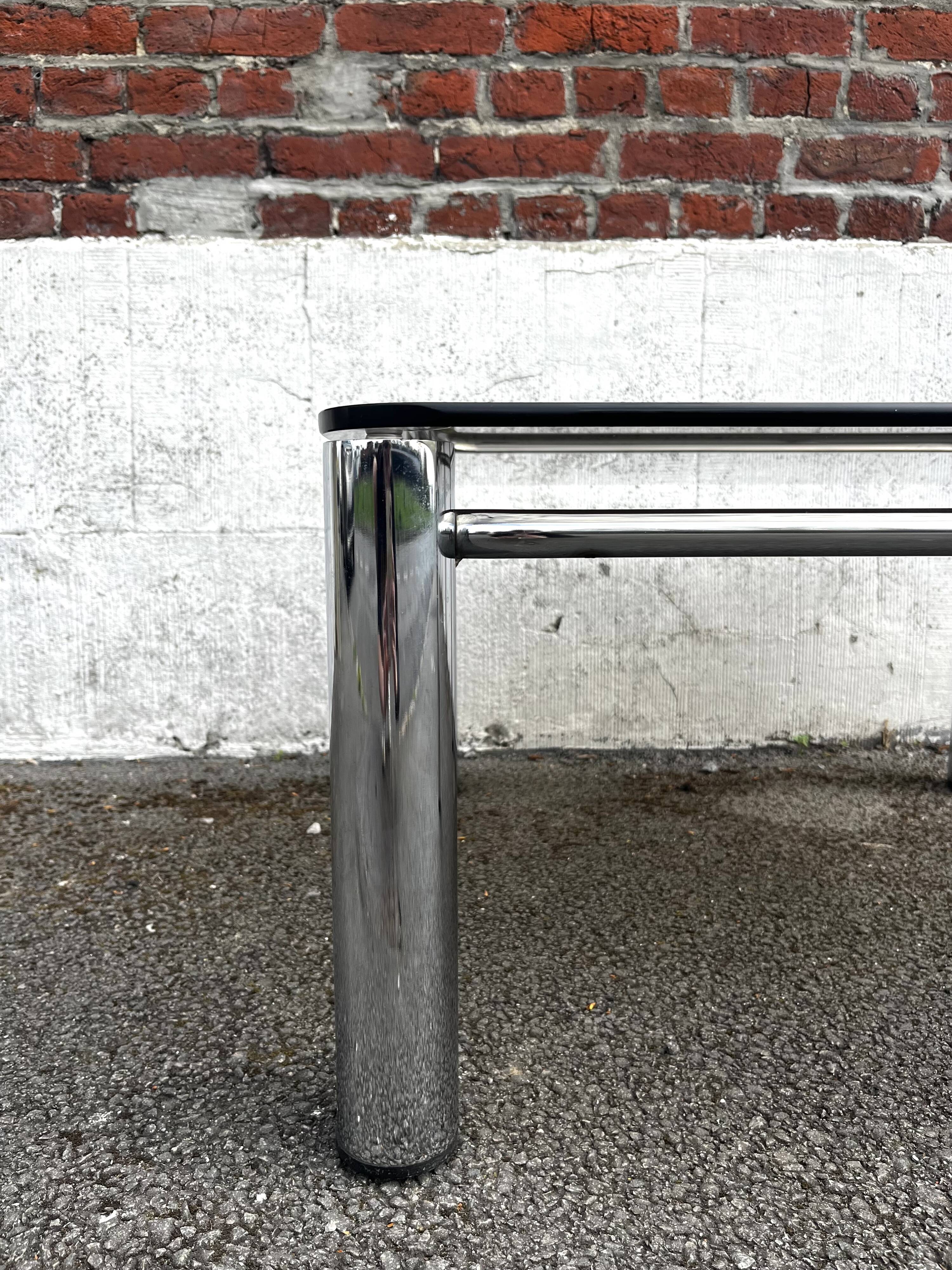 Vintage smoked glass coffee table with chrome structure.
