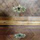 Antique marquetry commode in the Louis XVI style.