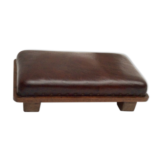 Old footrest in oak wood and leather