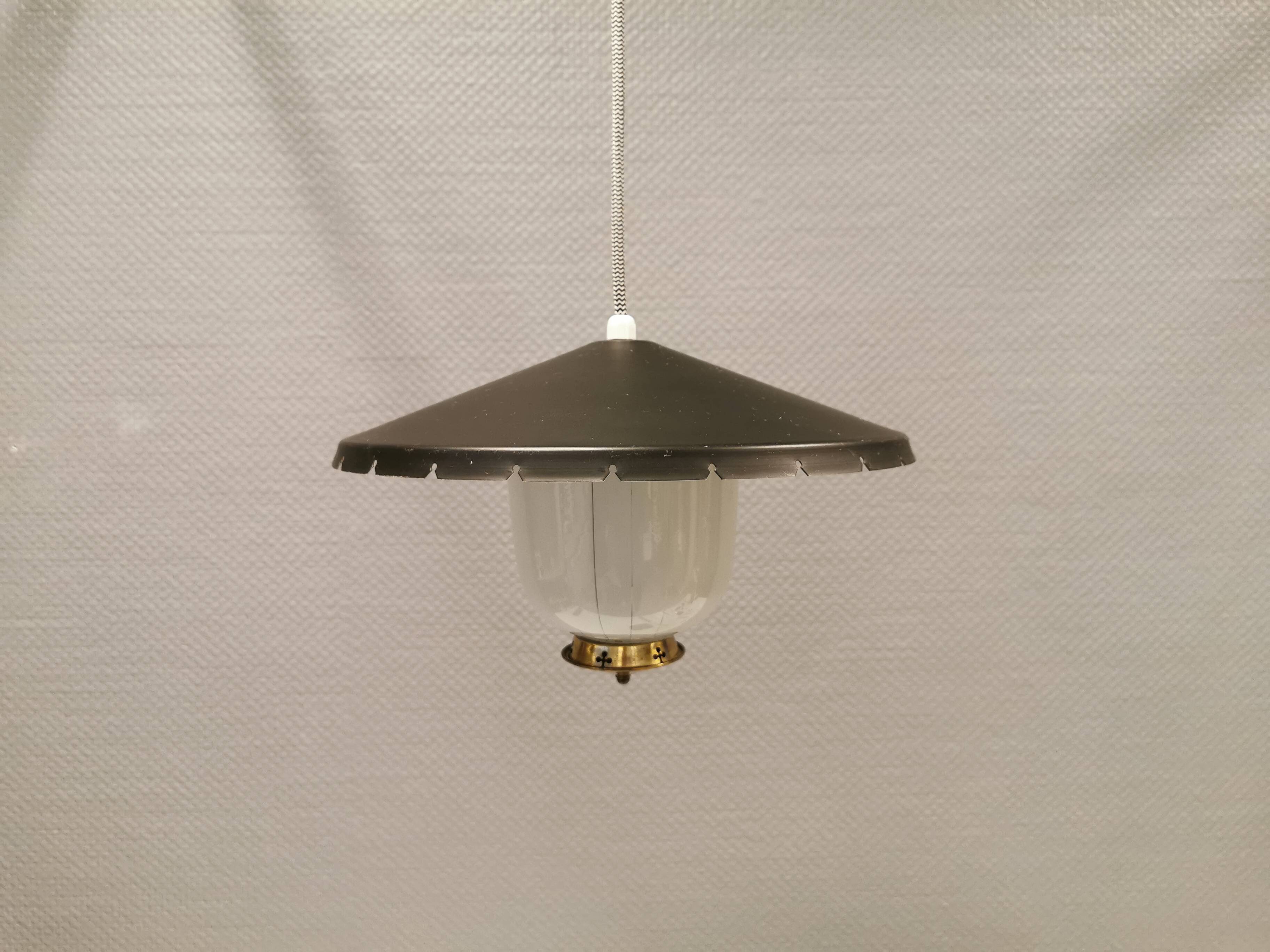 Hanging lamp in glass with black lacquered metal shade and brass base.