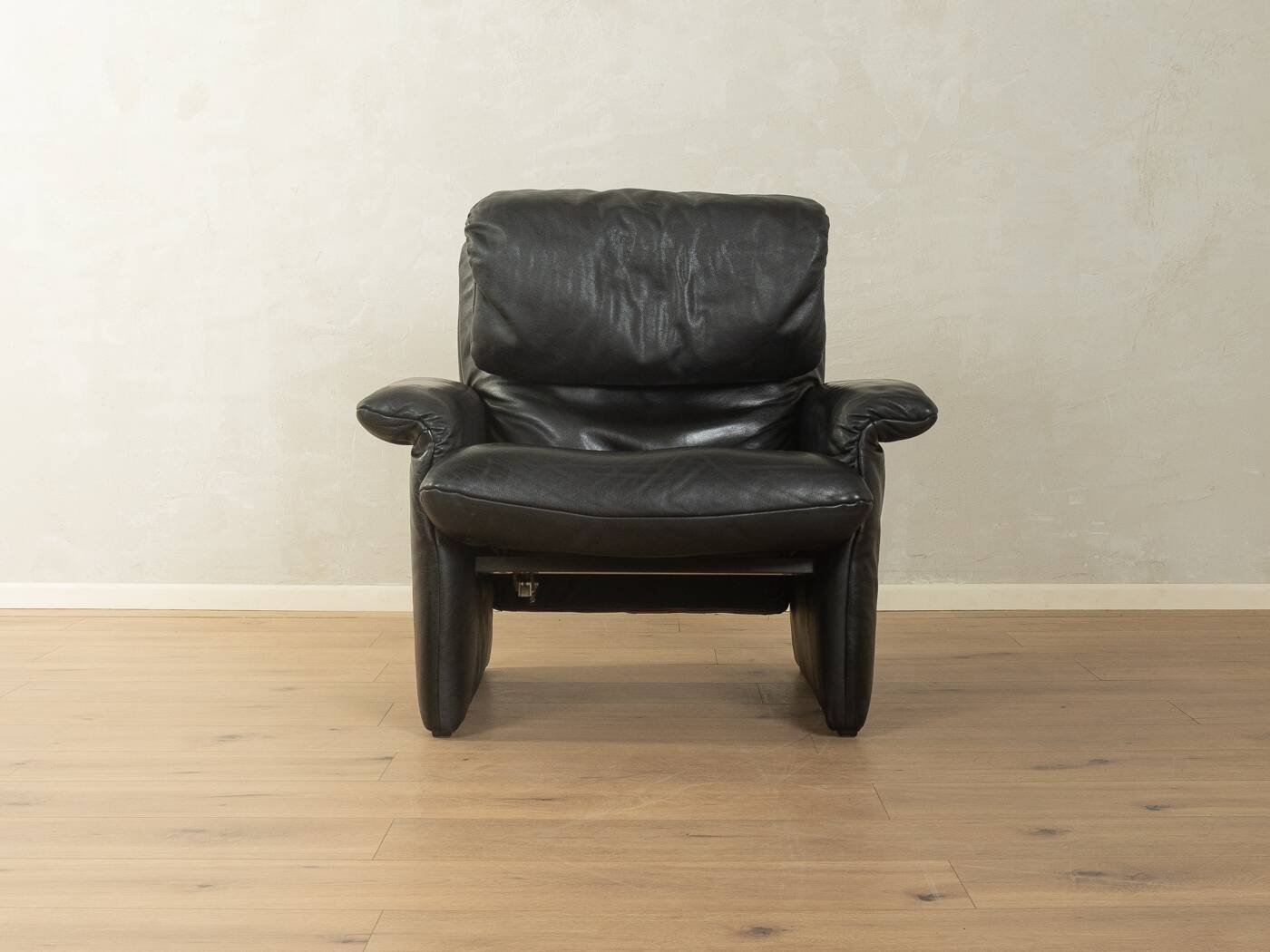 1980s cor armchair and ottoman in black leather