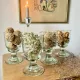 4 stemmed glasses made of handcrafted blown glass in green hue.