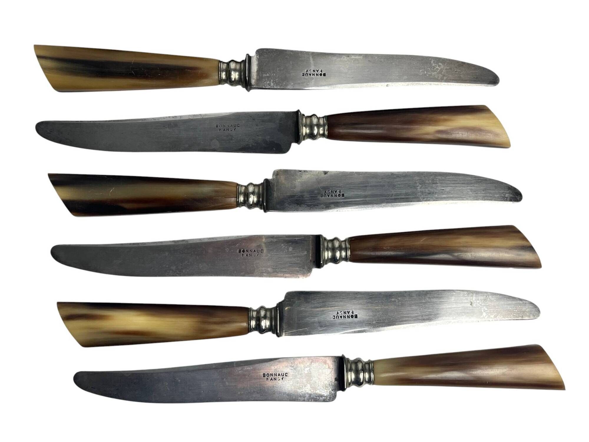 Six knives with steel blades and horn handles, Bonnaud Nancy, early 20th century.