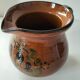 Glazed earthenware pitcher signed HR with a design of stylised birds.