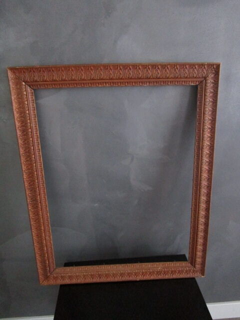 Large old frame in worked wood