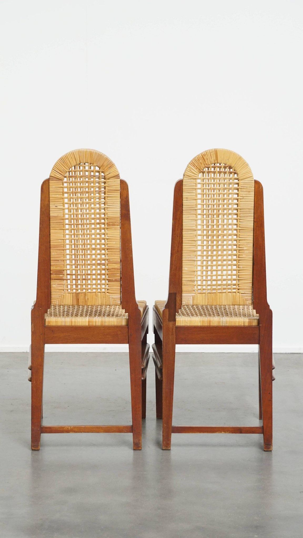 Ensemble de quatre chaises de salle à manger en rotin au design Art Déco avec dossier haut.