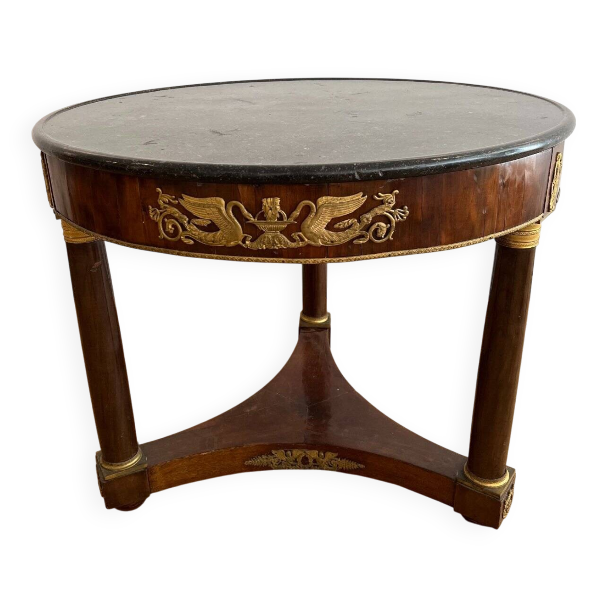 Empire gueridon in mahogany veneer adorned with chiselled and gilded bronze, topped with black marble with a groove.