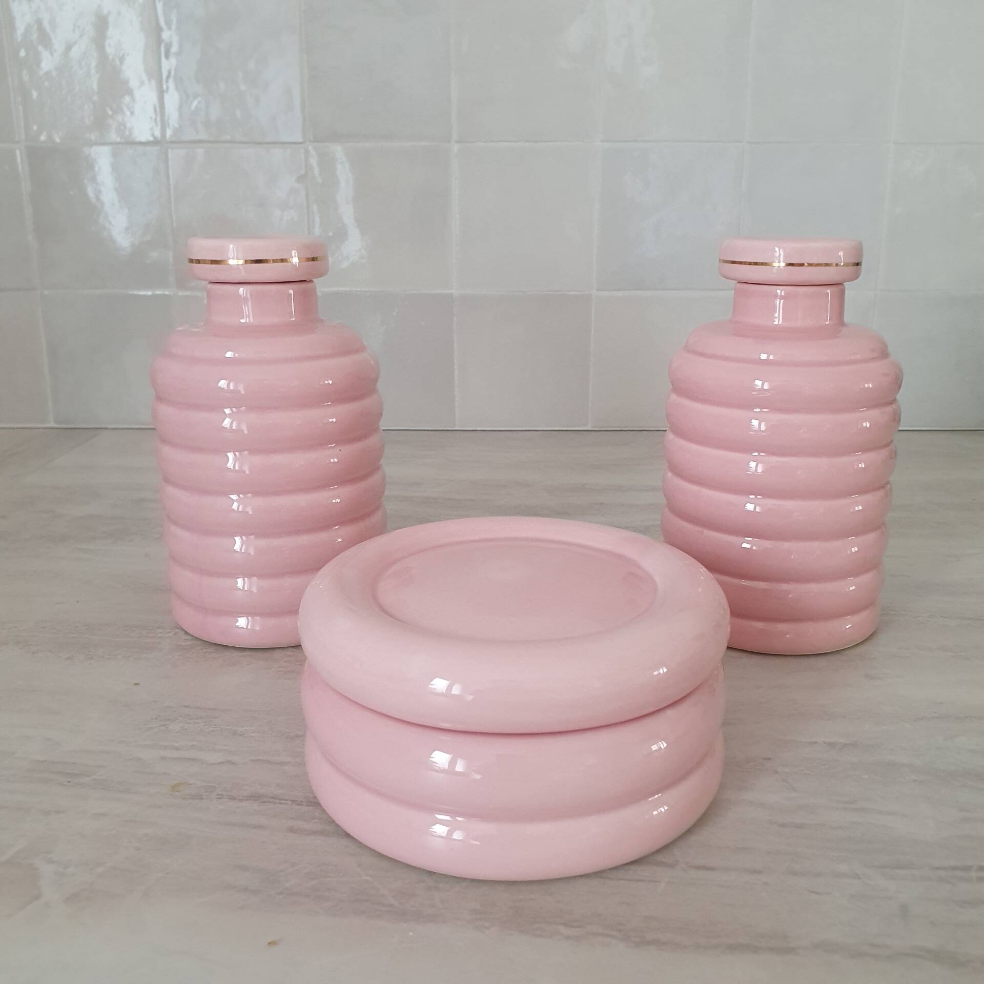 Set of pink and gold ceramic bathroom accessories