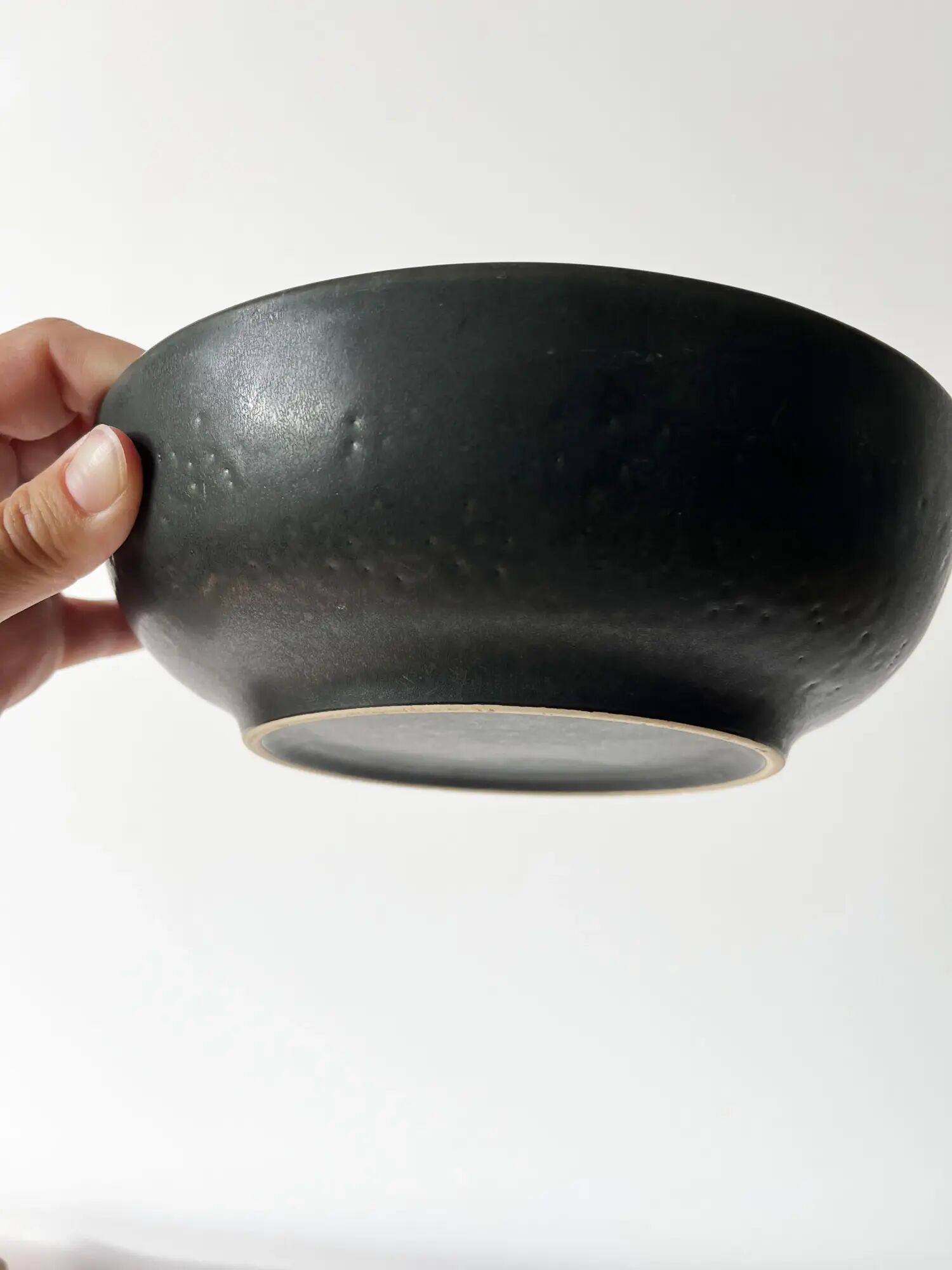 Round vintage black ceramic catchall.