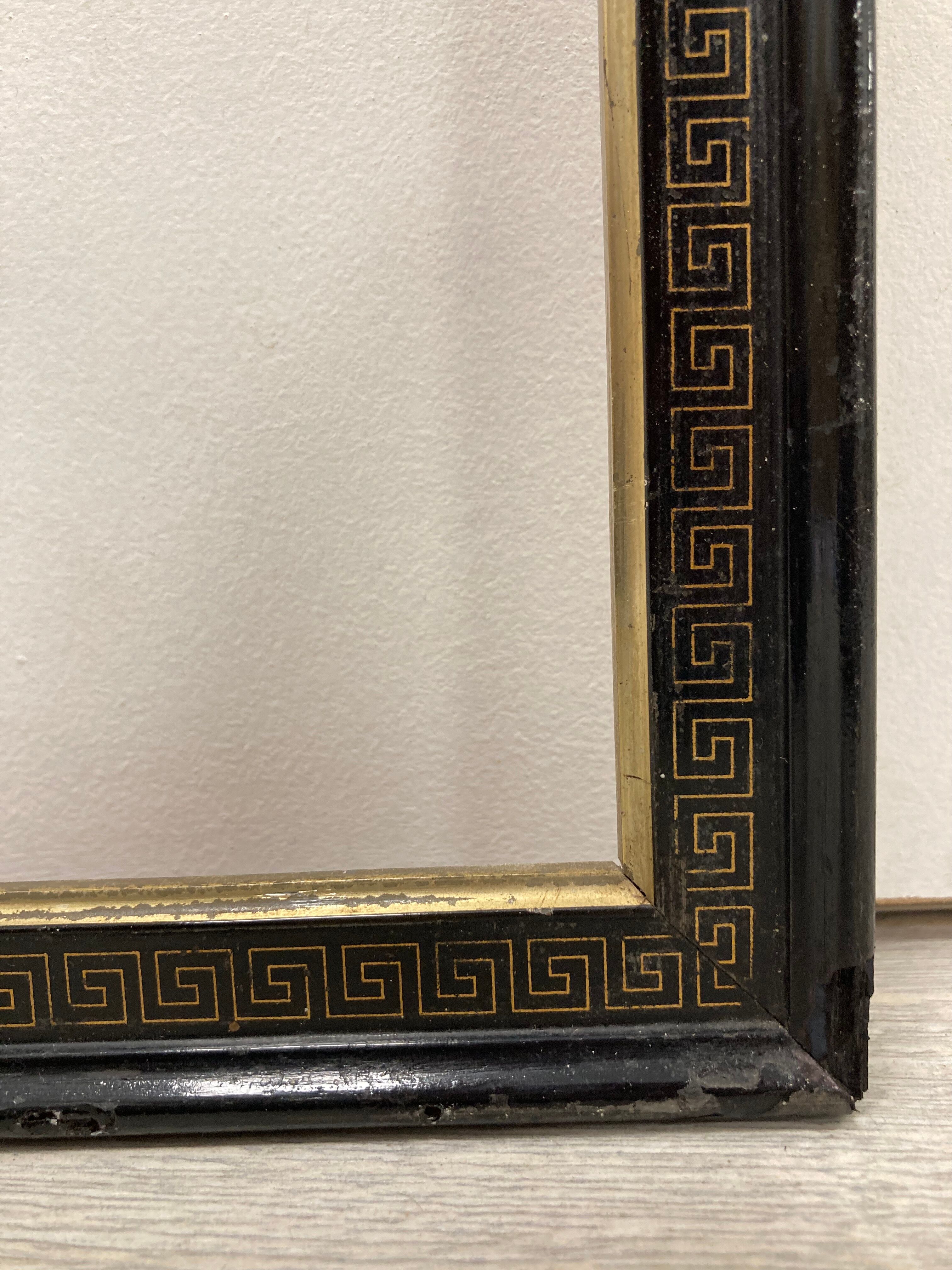 Black and gold frame decorated with Greek frieze decoration