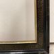 Black and gold frame decorated with Greek frieze decoration