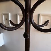Dark wooden parrot coat holder