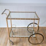 Serving table in gilded metal and glass with large wheels 1950
