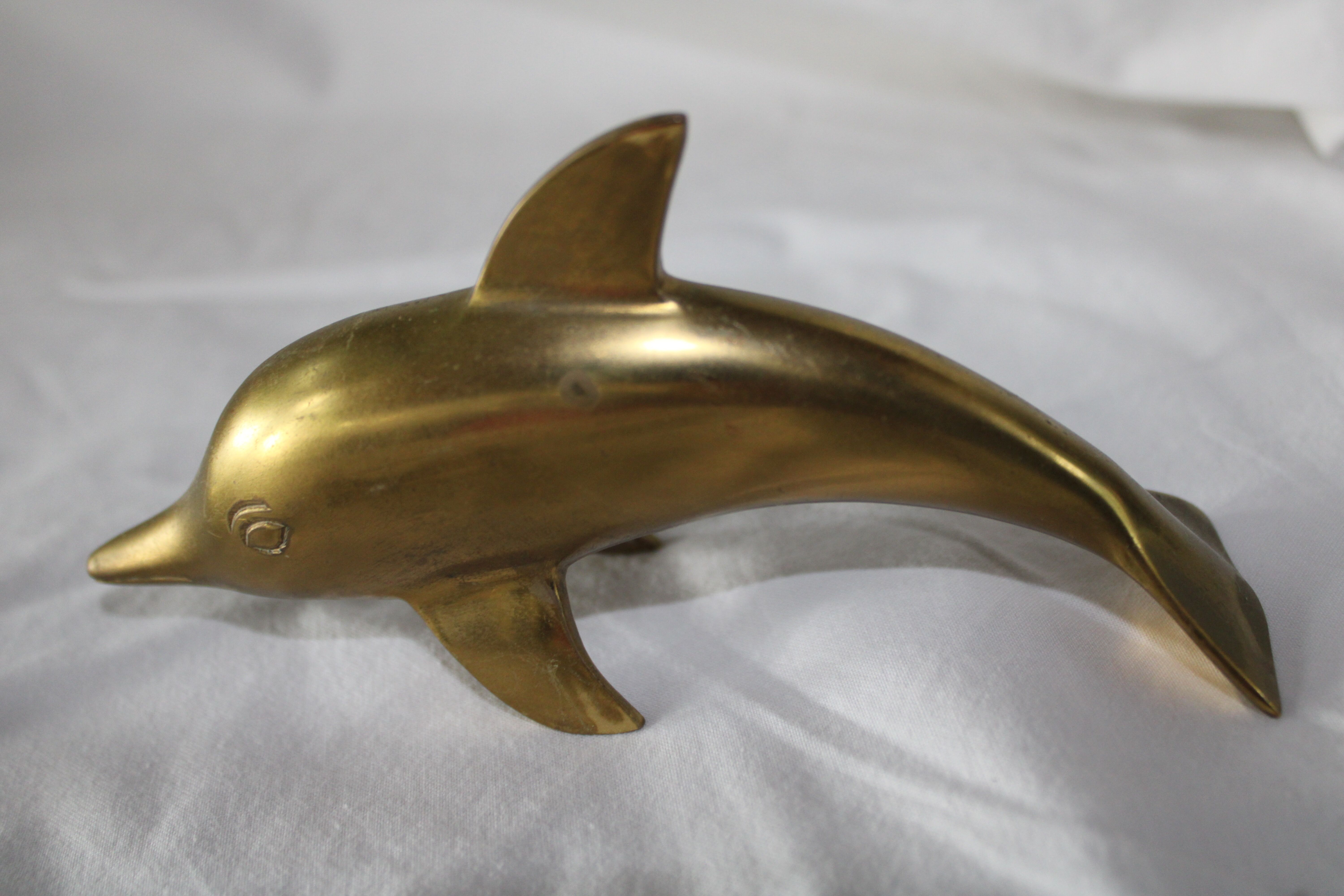 Family of dolphins in vintage brass