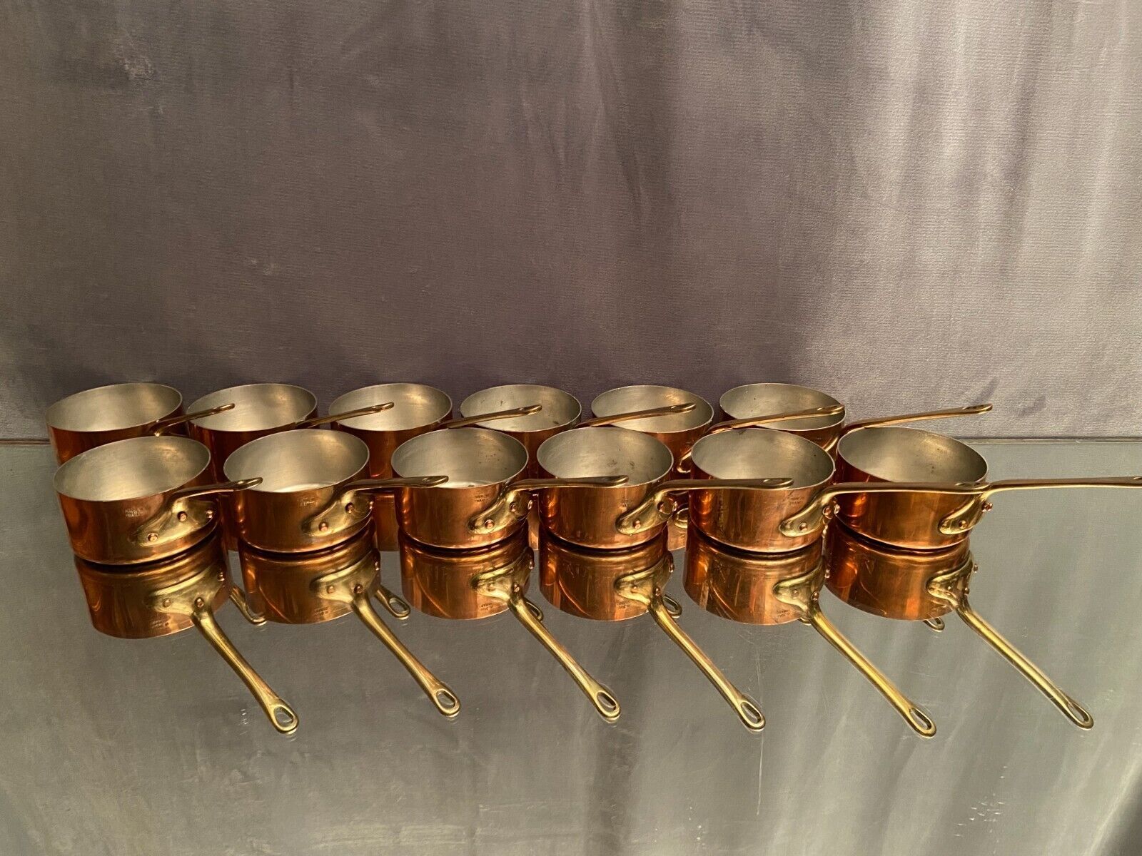 Suite of 12 tinned copper pans