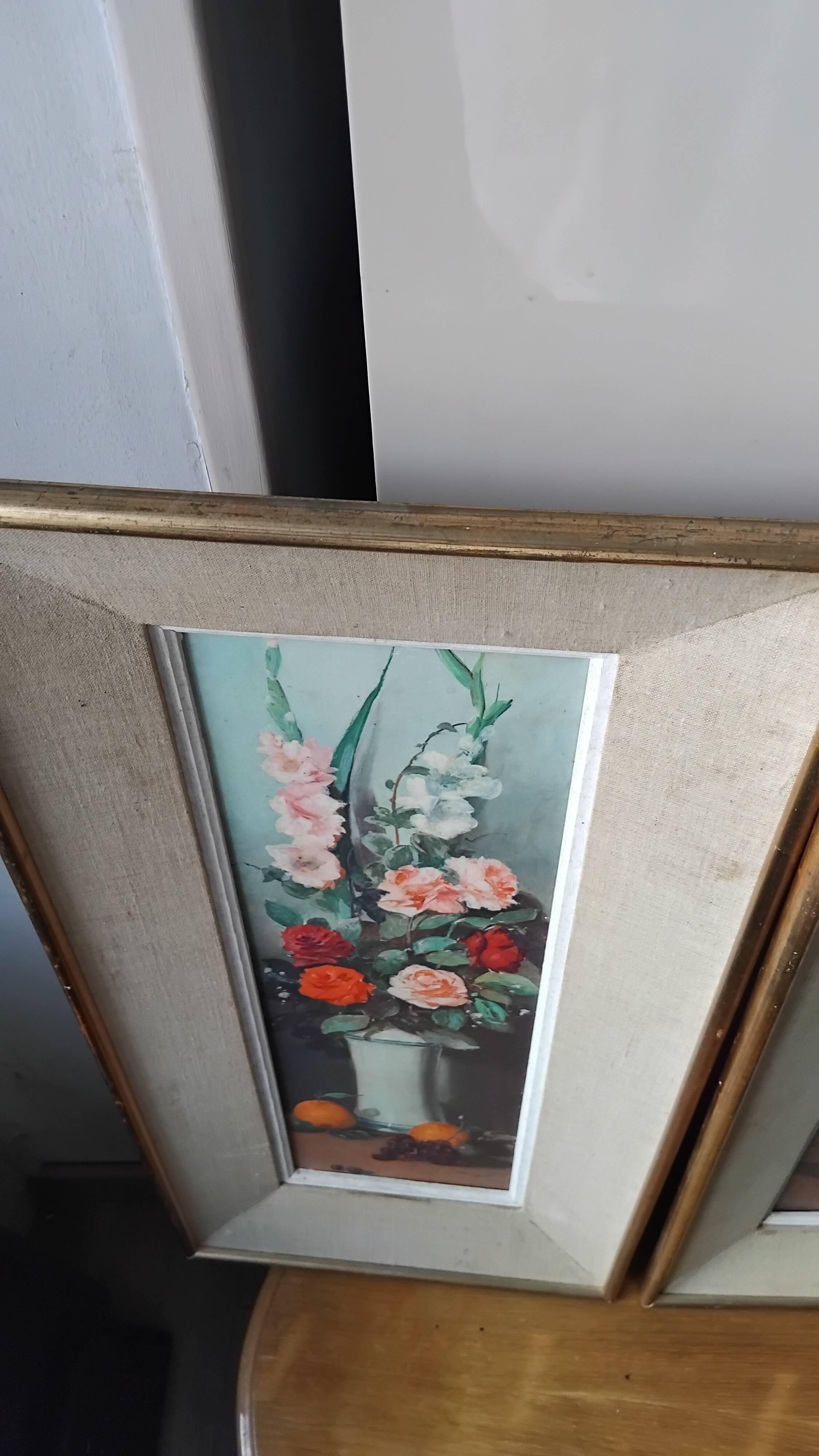 Pair of framed paintings featuring a composition of flowers.