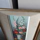 Pair of framed paintings featuring a composition of flowers.