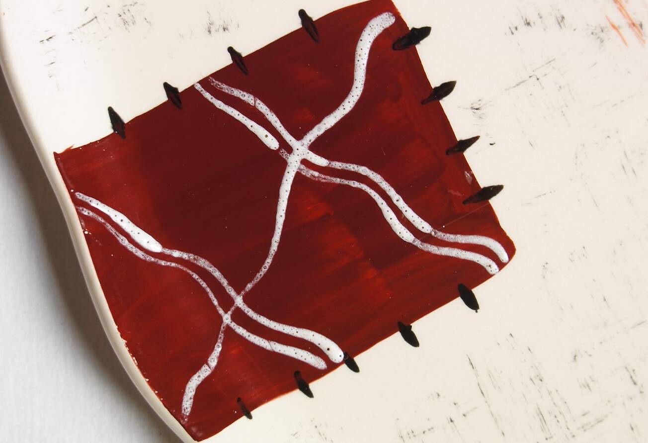 Large Longwy dish, hand-painted Harlequin model