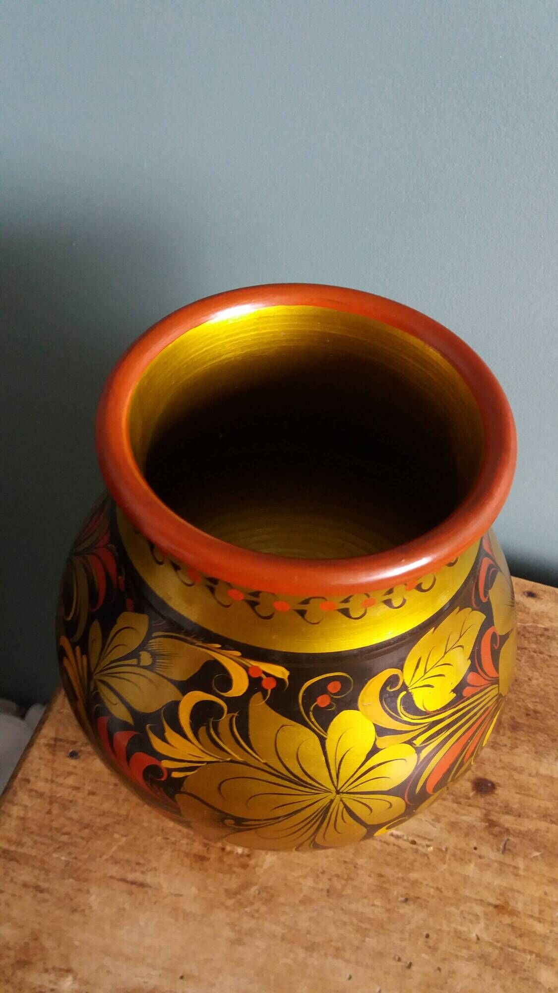 Khokhloma vase, Russian lacquered wood craftsmanship, hand-painted floral decoration.