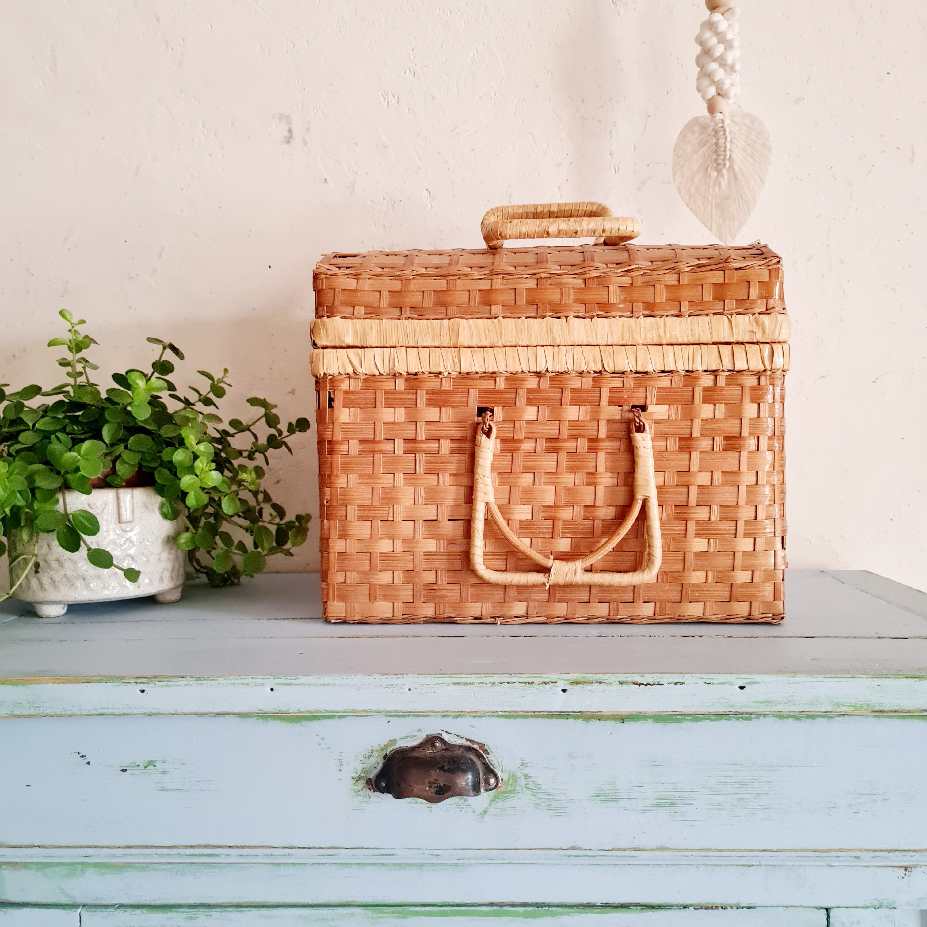Small suitcase in vintage rattan trunk