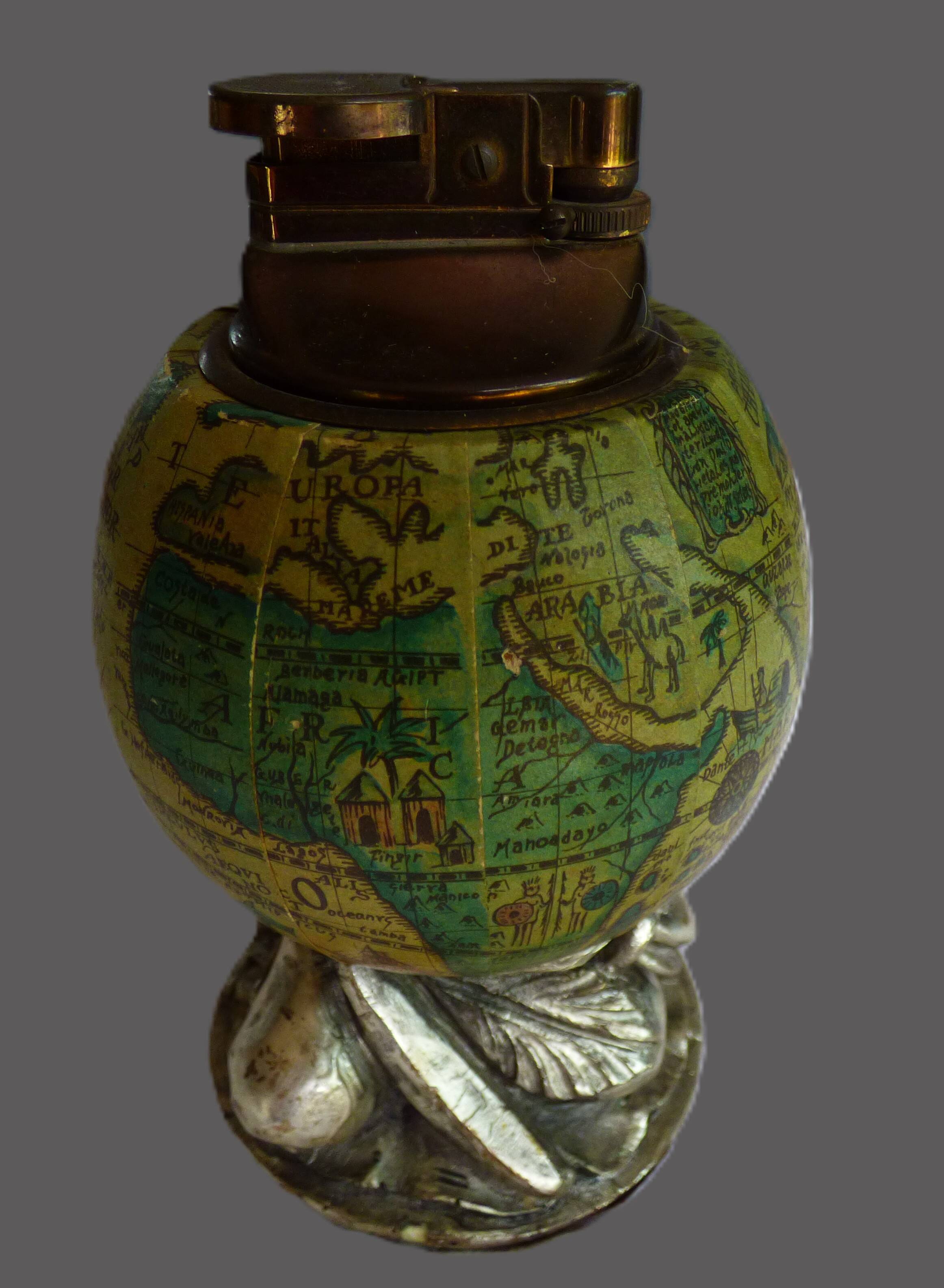 Vintage antique lighter with a globe and silver-plated stand.