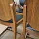 Set of four vintage wooden dining chairs with black leather upholstery, 85 × 45 × 45 cm