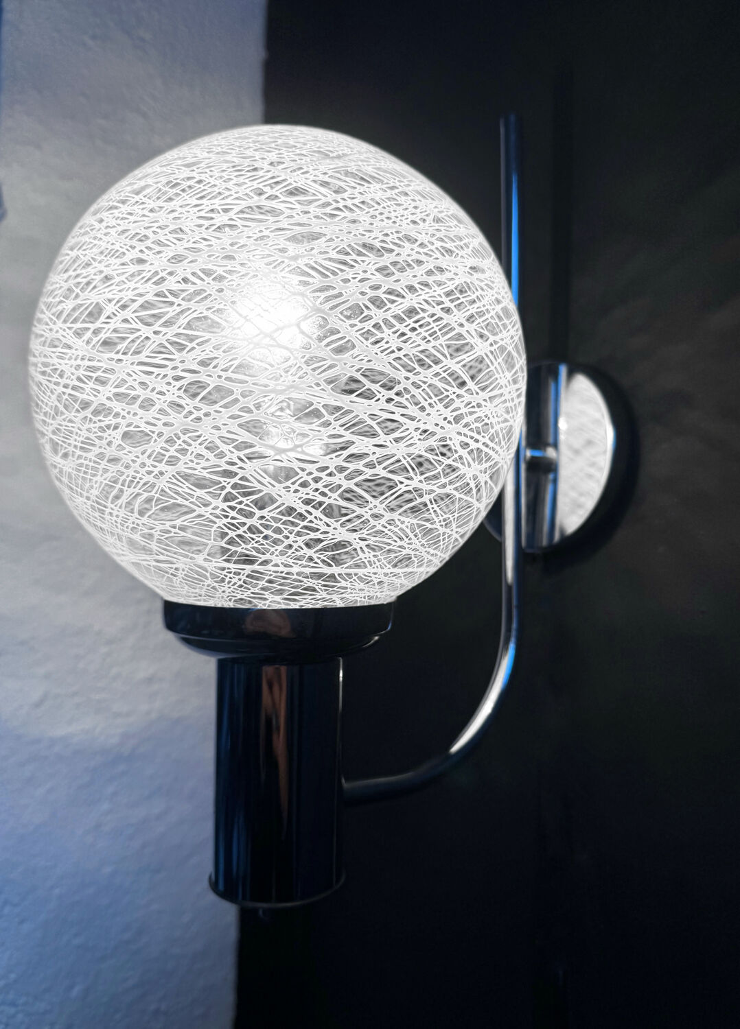 Chrome wall light with blown glass from the 1970s.