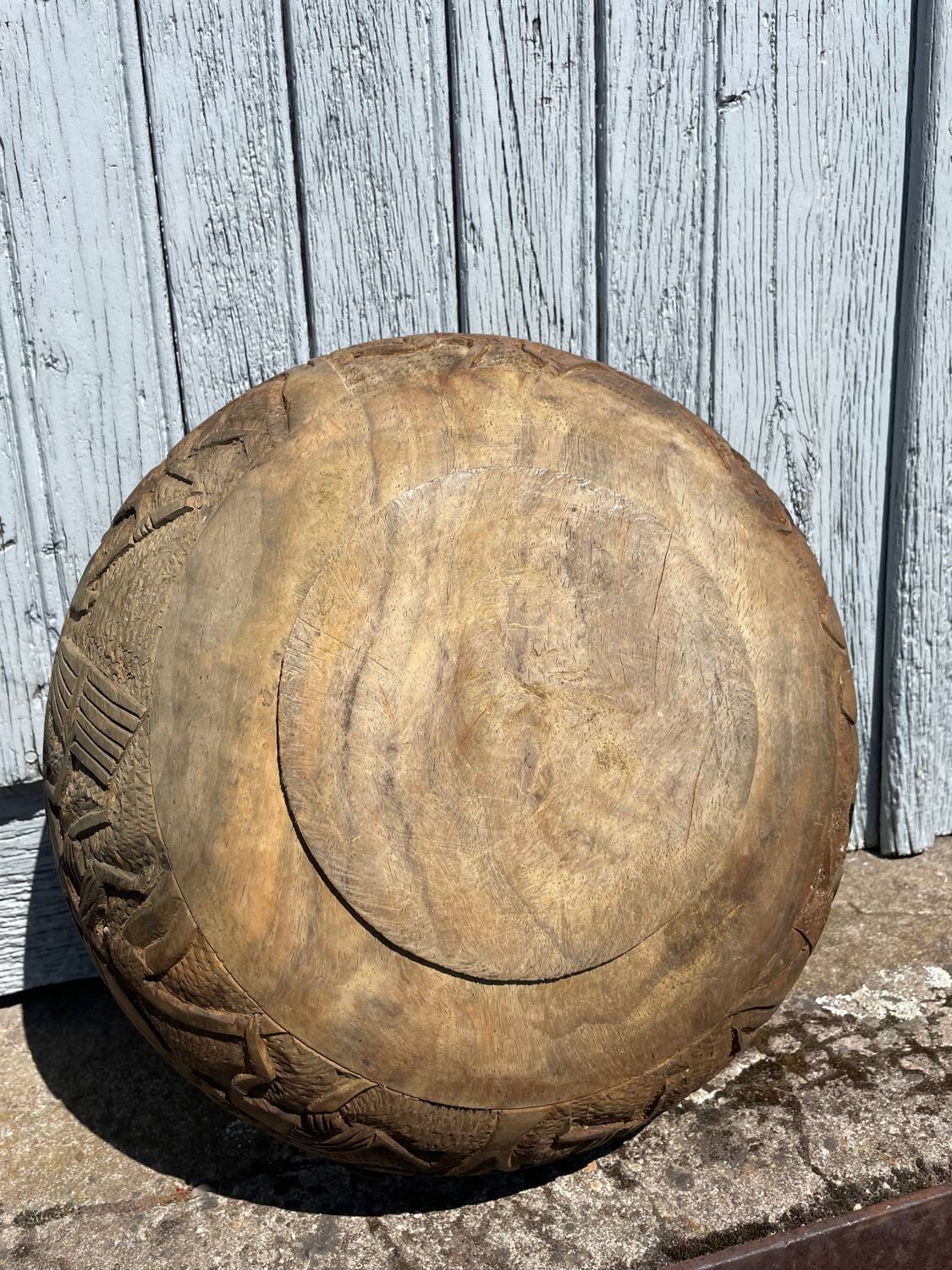 Old carved wooden bowl with African decoration.