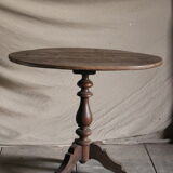 Old oval pedestal table in raw wood