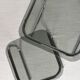 Pair of nesting tables in smoked glass and chrome legs.