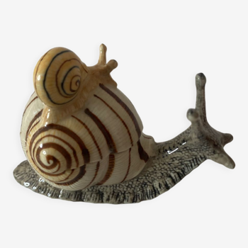 Porcelain figurine snail and its small