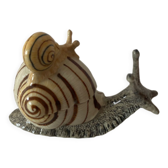 Porcelain figurine snail and its small
