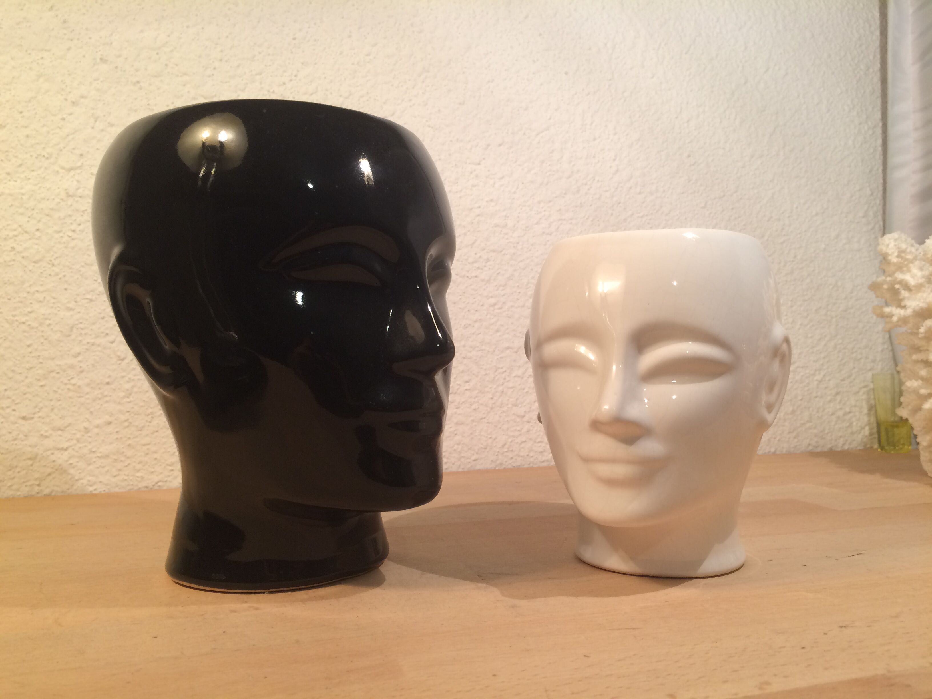 2 black and white ceramic head vases, face