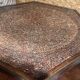 Handcrafted hexagonal wooden table with natural decor.